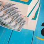 stack of cash next to the amazon logo